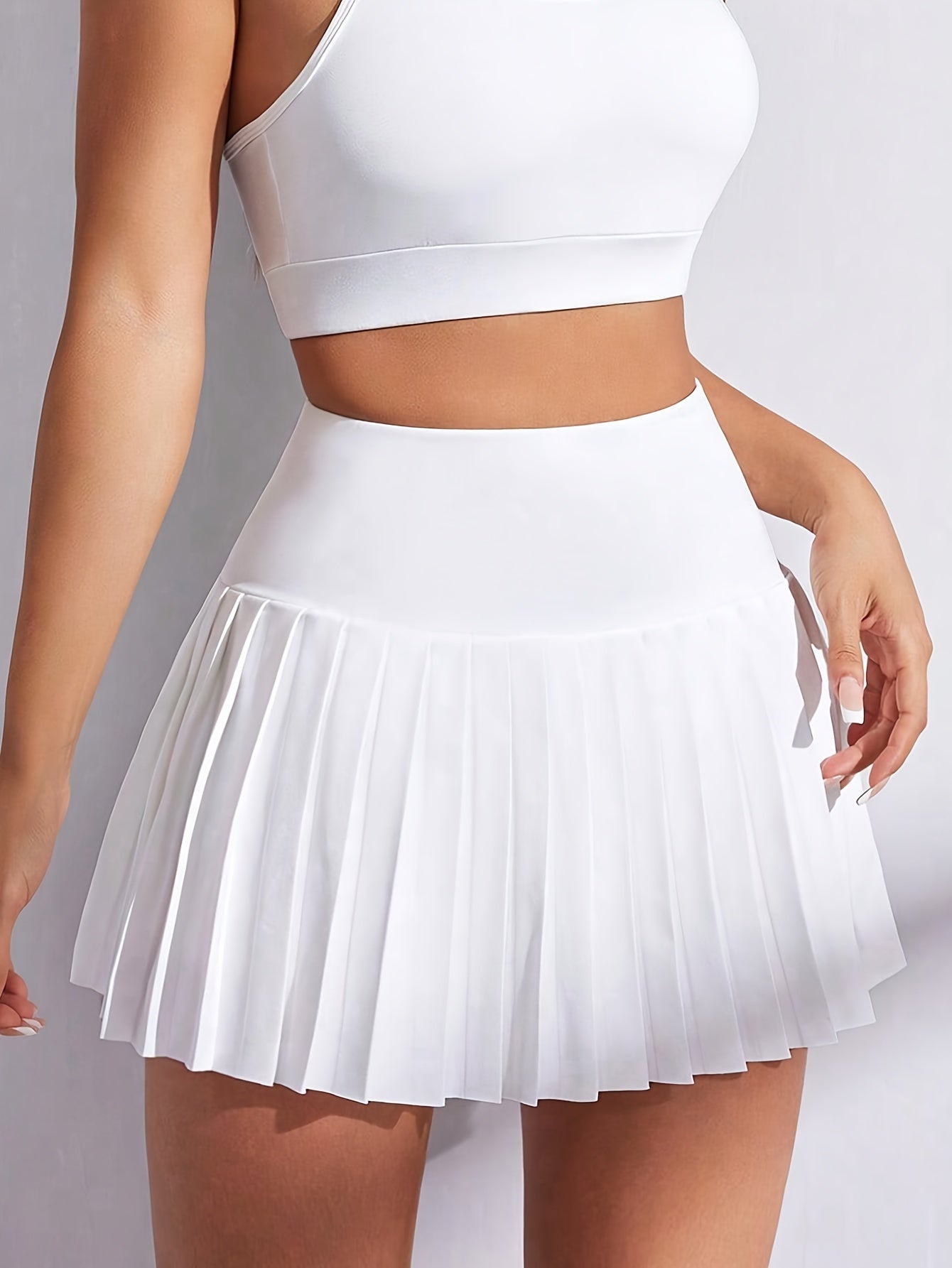 Women’s high-waisted pink skirt with pockets, stretchy polyester, ruffled hem.