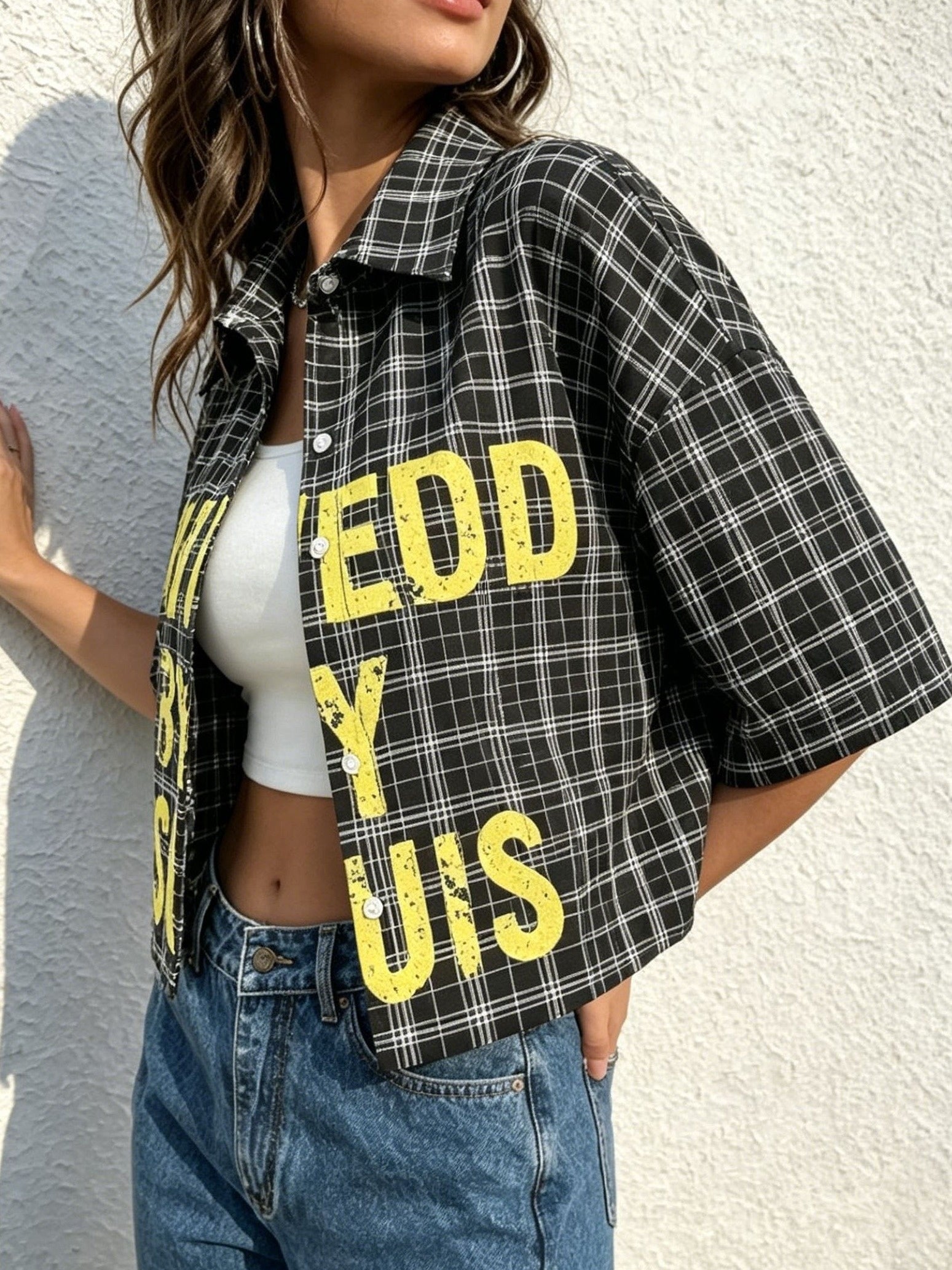 Teen Cropped Short-sleeve Plaid Shirt with Exposed Waist, Featuring an Oversized Loose Fit. The Classic Black and White Fine Plaid Base Is Paired with Bold, Distressed Lettering. This Vintage Streetwear Style Blends 90s Grunge, Skateboard Streetwear