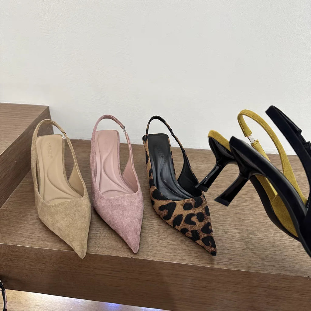 Elegant pointed stiletto sandals with leopard print design.