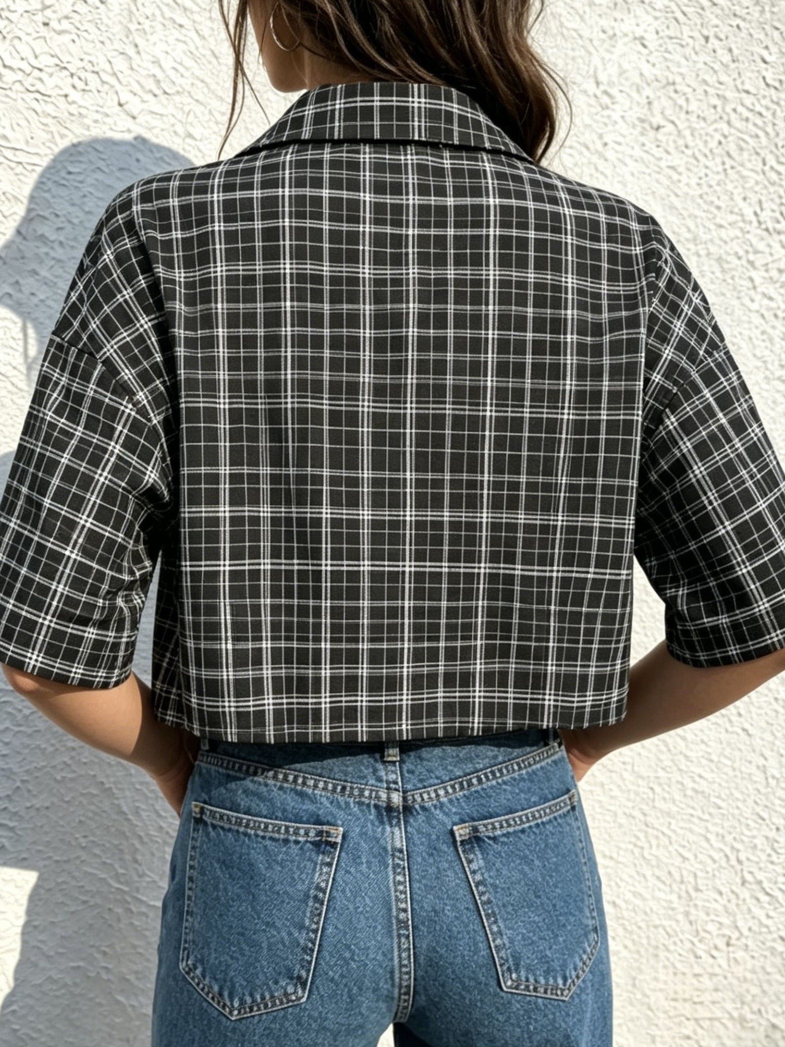 Teen Cropped Short-sleeve Plaid Shirt with Exposed Waist, Featuring an Oversized Loose Fit. The Classic Black and White Fine Plaid Base Is Paired with Bold, Distressed Lettering. This Vintage Streetwear Style Blends 90s Grunge, Skateboard Streetwear